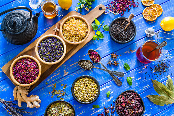 istock Herbal tea: various dried tea leaves and flowers shot from above on blue table 1202306487