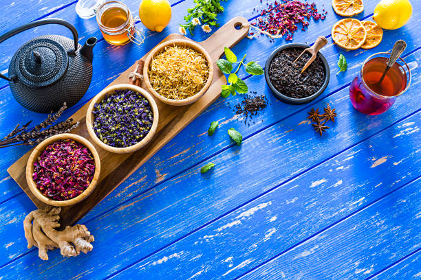 istock Herbal tea: various dried tea leaves and flowers shot from above on blue table. Copy space 1202306527