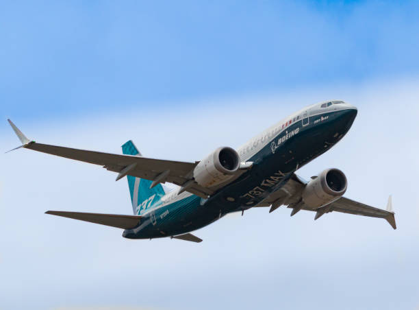 The Boeing 737-Max HAMPSHIRE, UK - JULY, 2018: The Boeing 737-Max passenger plane in-flight, before being grounded for safety reasons . July 18, 2018 Hampshire, England airplane crash photos stock pictures, royalty-free photos & images