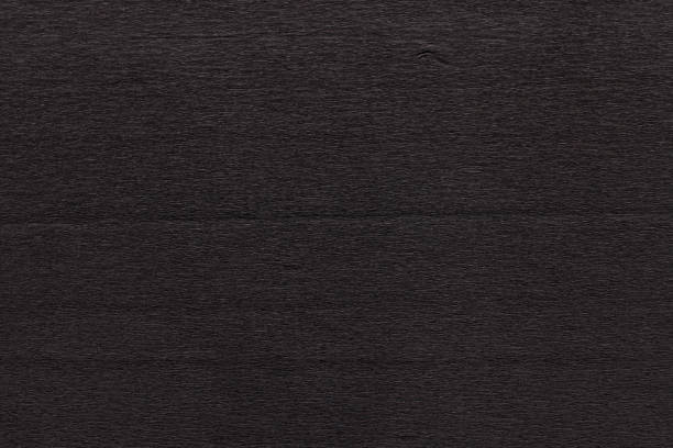 istock Texture of dark black corrugated thin uneven paper 1202307522