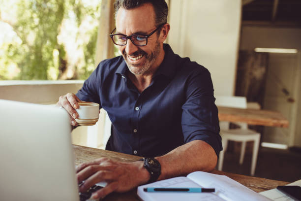 istock Man doing his work sitting at a coffee shop 1202307718