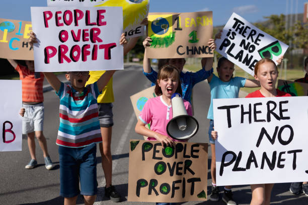 istock Group of elementary school pupils walking on a protest march 1202308455