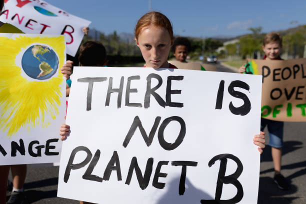 istock Group of elementary school pupils walking on a protest march 1202308548