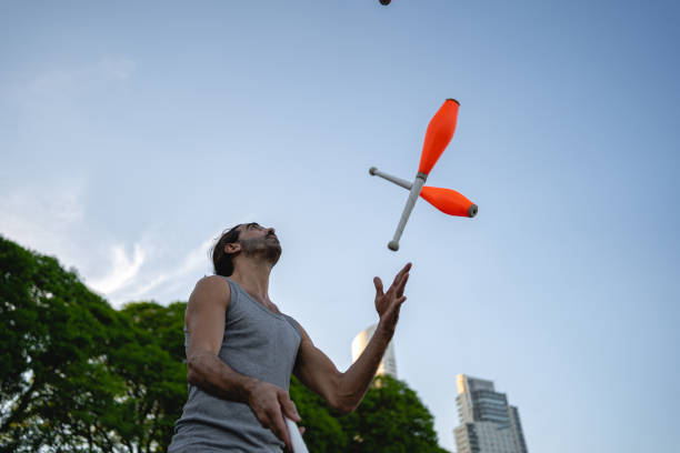 istock Hispanic street performer juggling cones in public park 1202308888