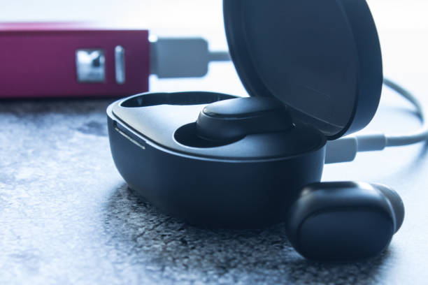 istock headphones in a case charging from a charger 1202310483