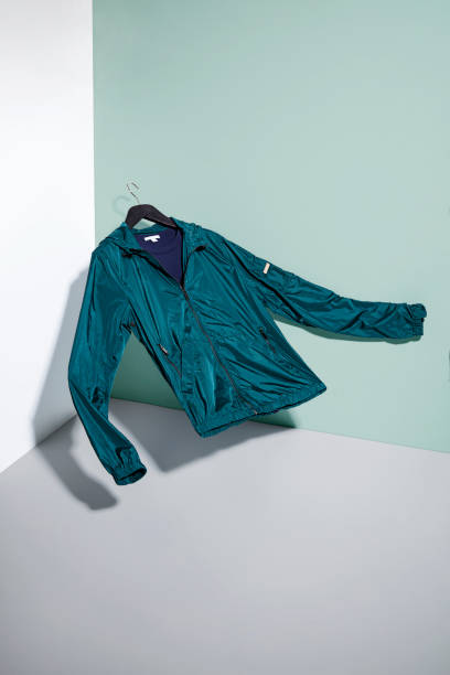 Green raincoat on hanger isolated on backgrounds (with clipping path)