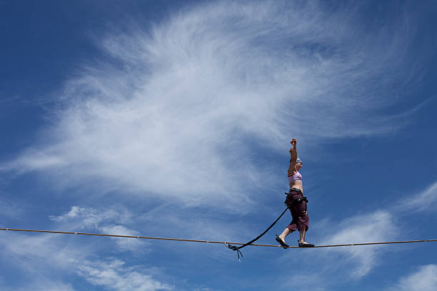 istock Female Highliner Walks a Highline with Sky & Clouds 120231233