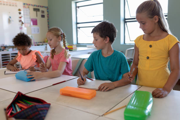 istock Group of schoolchildren working in an elementary school classroom 1202312354