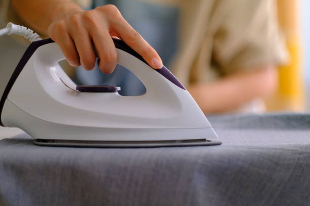 istock ironing hand on iron cloth household 1202313382