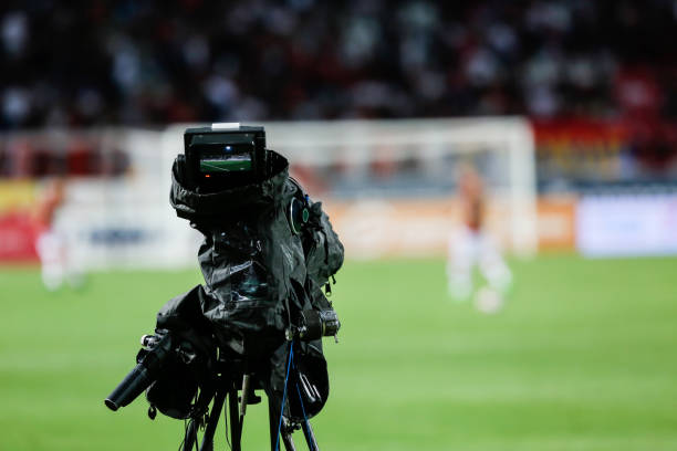 istock TV camera at the stadium, broadcasting during a football (soccer) match 1202313612