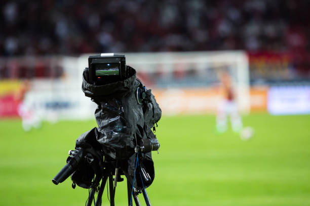 istock TV camera at the stadium, broadcasting during a football (soccer) match 1202313657