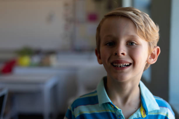 istock Schoolboy looking at camera in an elementary school classroom 1202313718