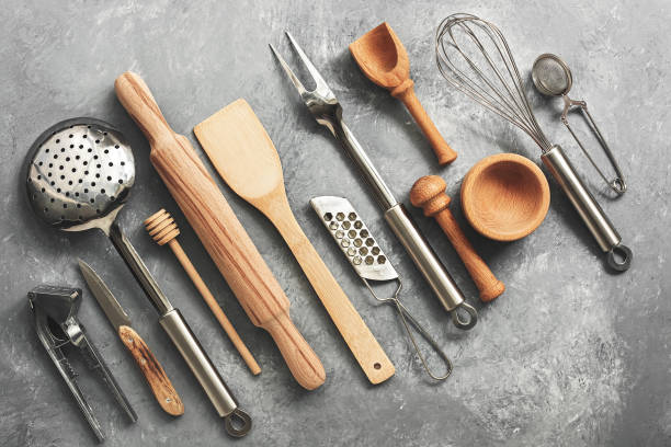 istock A variety of kitchen utensils and tools on a gray concrete rustic background. Top view, flat lay, copy space. 1202313800
