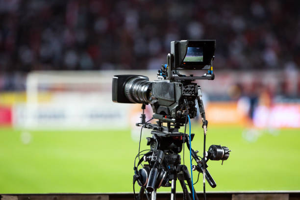 tv camera at the stadium, broadcasting during a football (soccer) match - broadcasting imagens e fotografias de stock