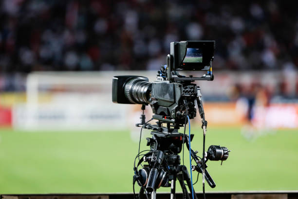 TV camera at the stadium, broadcasting during a football (soccer) match stock photo