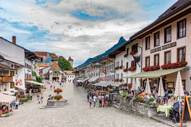 2019 Gruyeres, Switzerland Beautiful view of the medieval town of Gruyeres, home to the world-famous Le Gruyere cheese, canton of Fribourg, Switzerland. There are tourists in the main street. fribourg city switzerland stock pictures, royalty-free photos & images
