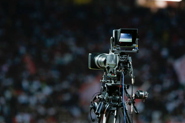 istock TV camera at the stadium, broadcasting during a football (soccer) match 1202314143