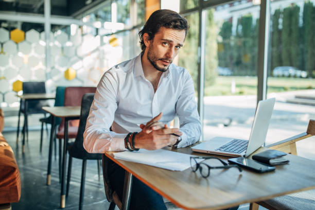 istock Businessman working on laptop in cafe 1202314200
