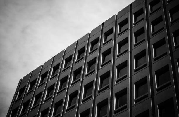 istock Black office building with many windows. 1202315013