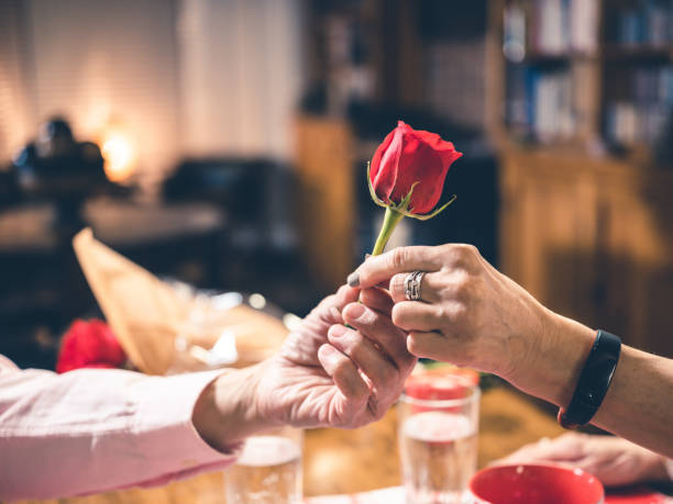 istock Hands of Senior couple at Valentines Dinner 1202316916