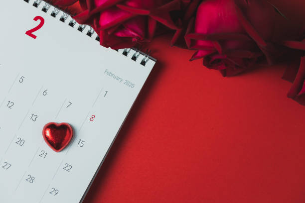 istock White paper calendar and red rose placed on a red background 1202318217
