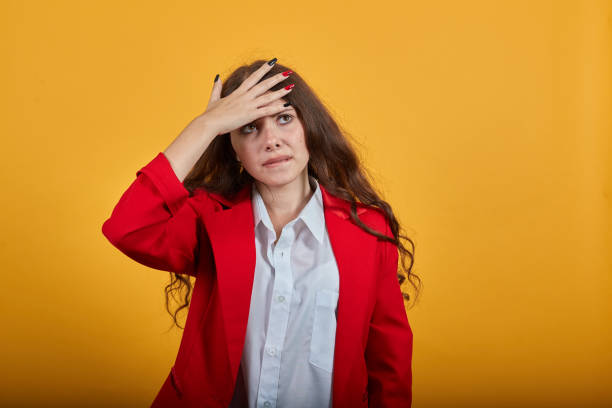 istock Shocked brunette young woman keeping hands on head, having headache, confused 1202319338