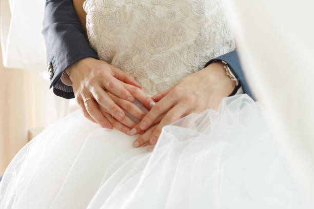 istock newlyweds are hugging.  close-up, hands 1202320686