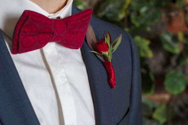 istock red bow tie and boutonniere on a man’s suit 1202320782