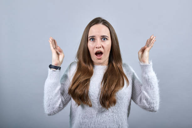 istock Surprised attractive lady spreads hands, opened mouth, looking at camera. 1202325712