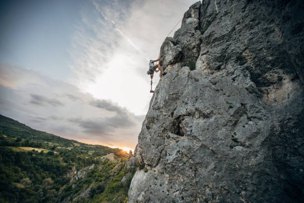 istock Man with prosthetic leg free rock climbing 1202325991