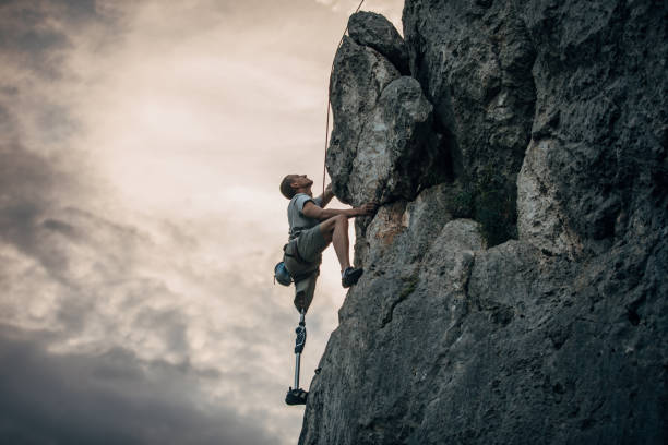 istock Disability man free rock climbing 1202326206