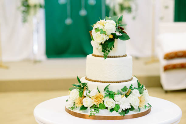 istock White and green wedding cake with flowers at reception 1202326918
