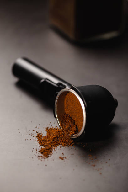 istock Portafilter with ground coffee over black background with place for text 1202327553