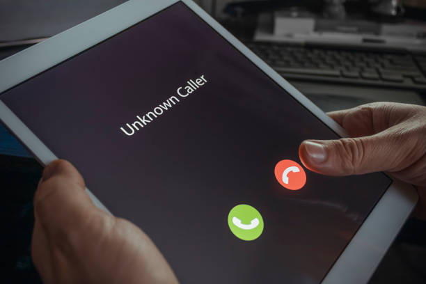istock Unknown caller. A man holds a tablet in his hand and thinks to end the call. Incoming from an unknown number at night. Incognito or anonymous 1202330393