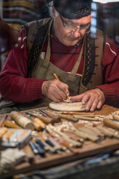 istock Senior artisan working on wooden figurine 1202331016