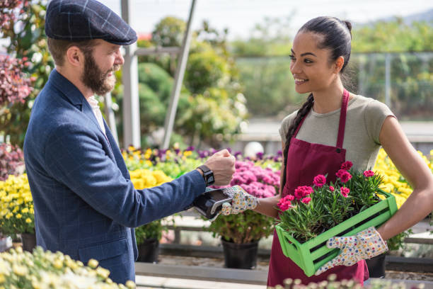 istock Man buying flowers and paying with his smart watch 1202331041