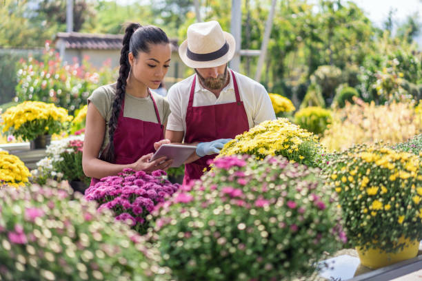 istock Gardeners examining the flower petals 1202331055