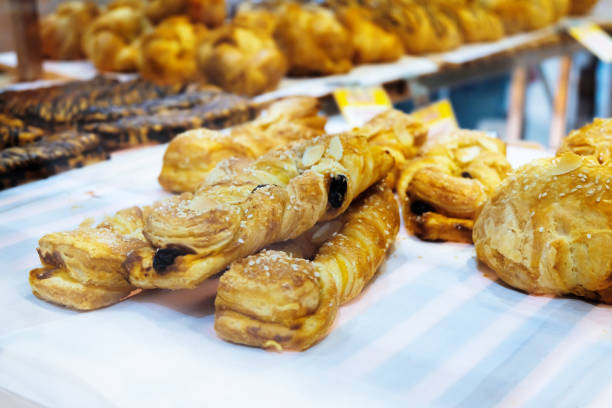 istock Soft bread food on shelf for sale inside bakery shop , soft focus. 1202331590