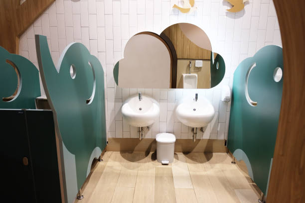 istock Small restroom with small toilet seats and sinks for kid 1202331596