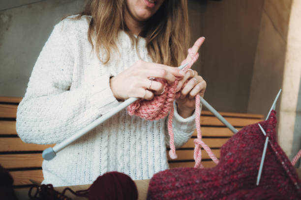 istock Close up on woman's hands knitting 1202331800