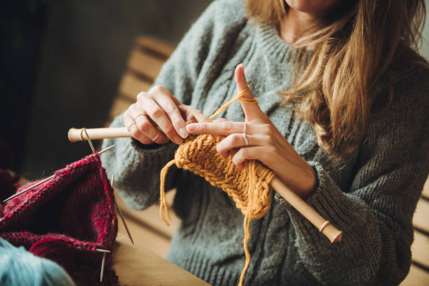 istock Close up on woman's hands knitting 1202331812