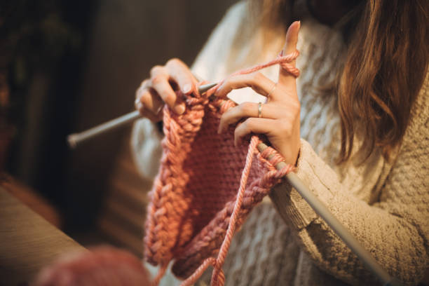 istock Close up on woman's hands knitting 1202331817