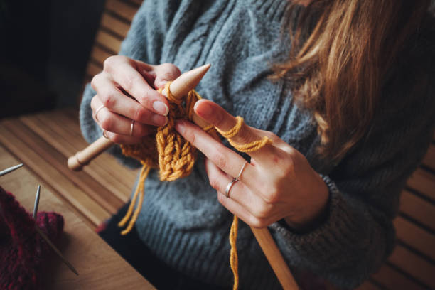 istock Close up on woman's hands knitting 1202331838