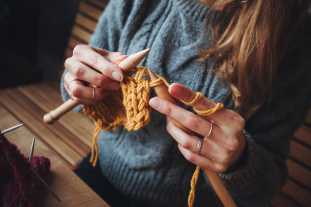 istock Close up on woman's hands knitting 1202331851