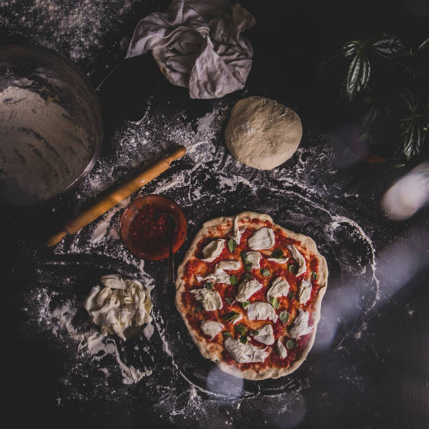 Close-up image of chef making pizza