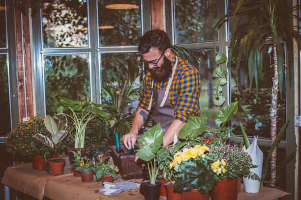 istock Gardener in a flower shop 1202331938