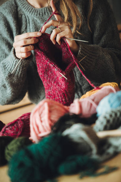 istock Close up on woman's hands knitting 1202331953