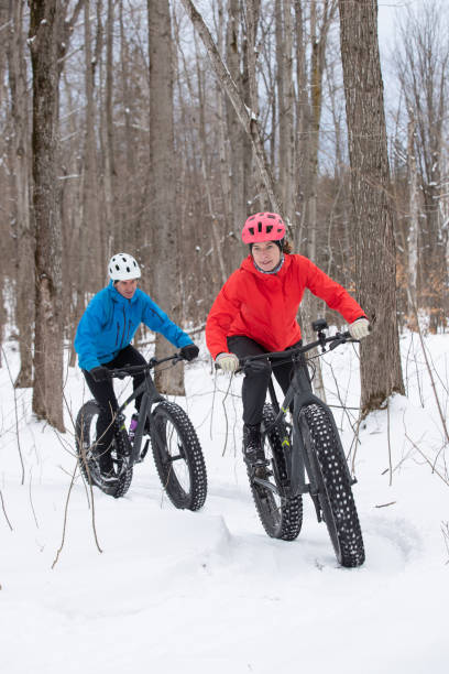 istock Attractive couple riding fat bikes in the snow 1202334585