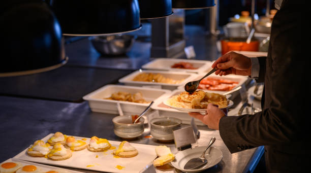istock Man pouring sauce over his breakfast 1202336384