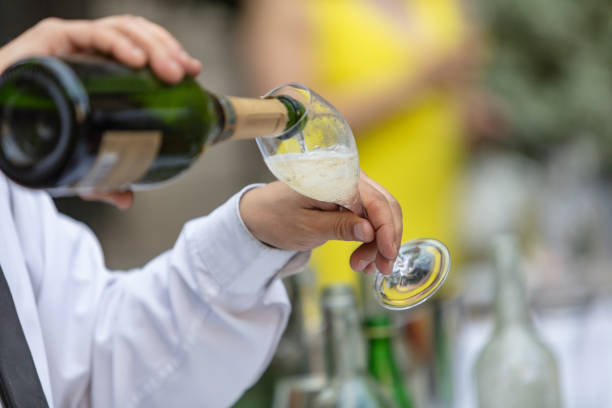 Waiter filling champagne flute